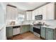 Bright kitchen features two-tone cabinets, open shelving, and stainless steel appliances at 934 Hope Dr, Atlanta, GA 30310