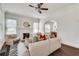 Bright living room with a decorative fireplace, white walls, hardwood floors and ceiling fan at 934 Hope Dr, Atlanta, GA 30310