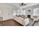 Bright living room with a decorative fireplace, white walls, hardwood floors and an entry door at 934 Hope Dr, Atlanta, GA 30310