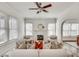 Bright living room with a decorative fireplace, white walls, ceiling fan and hardwood floors at 934 Hope Dr, Atlanta, GA 30310