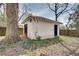 Shed in backyard with dual doors, mature trees, lawn, and privacy fence at 934 Hope Dr, Atlanta, GA 30310