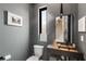 Contemporary half bathroom with a sleek vanity, modern fixtures, and a stylish mirror at 1307 Glenwood Se Ave, Atlanta, GA 30316