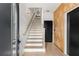 Inviting entryway featuring hardwood floors, a wooden accent wall, and a staircase with white risers at 1307 Glenwood Se Ave, Atlanta, GA 30316