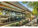 Charming building with roll-up doors, showcasing an inviting outdoor patio and green landscape at 1307 Glenwood Se Ave, Atlanta, GA 30316