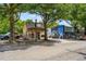 Street view of two-story mixed-use buildings with colorful facades and mature trees along the sidewalk at 1307 Glenwood Se Ave, Atlanta, GA 30316