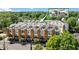 Modern townhome exterior showcasing a rooftop deck with outdoor kitchen and dining, surrounded by lush greenery at 1307 Glenwood Se Ave, Atlanta, GA 30316