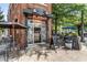 The Flatiron restaurant offers sidewalk seating under shady umbrellas on a tree lined street at 1307 Glenwood Se Ave, Atlanta, GA 30316