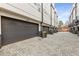 Exterior showing a row of townhome garages with gray doors and brick paved driveway at 1307 Glenwood Se Ave, Atlanta, GA 30316