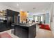 Open-concept kitchen with black cabinets, stainless steel appliances, and hardwood floors at 1307 Glenwood Se Ave, Atlanta, GA 30316