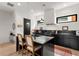 Modern kitchen featuring a black island, countertops, cabinets, stainless steel appliances and stylish pendant lighting at 1307 Glenwood Se Ave, Atlanta, GA 30316