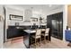 Bright kitchen featuring stainless steel appliances, black cabinetry and countertops, and a center island with seating at 1307 Glenwood Se Ave, Atlanta, GA 30316