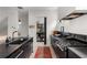 Contemporary kitchen with black cabinets, stainless steel appliances, and a view of the pantry at 1307 Glenwood Se Ave, Atlanta, GA 30316