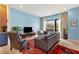 Comfortable living room with light blue walls, large windows, and stylish decor and a comfy seating area at 1307 Glenwood Se Ave, Atlanta, GA 30316