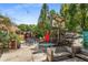 Cozy outdoor seating area with tables, chairs, umbrellas, and a rustic wooden bench at 1307 Glenwood Se Ave, Atlanta, GA 30316