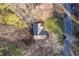 Overhead view of the home with a spacious yard, surrounded by trees and a quiet residential street at 150 Hartwood Dr, Woodstock, GA 30189
