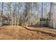 A spacious backyard with a raised deck backing onto a serene wooded area at 150 Hartwood Dr, Woodstock, GA 30189