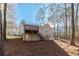 Back view of home featuring a deck, surrounded by tall trees in a natural setting at 150 Hartwood Dr, Woodstock, GA 30189