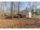 Home exterior showing the second story deck with access stairs in a heavily wooded setting at 150 Hartwood Dr, Woodstock, GA 30189