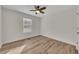 Bright bedroom features a window, ceiling fan, hardwood floors and light colored walls at 150 Hartwood Dr, Woodstock, GA 30189