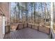 A quaint deck enclosed with decorative wooden lattice overlooking a wooded backyard at 150 Hartwood Dr, Woodstock, GA 30189