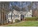 Charming one-story home featuring a well-maintained lawn and mature trees at 150 Hartwood Dr, Woodstock, GA 30189