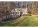 Charming home with manicured lawn, complemented by mature trees and a welcoming front entrance at 150 Hartwood Dr, Woodstock, GA 30189