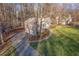 Rear view of the home, with mature trees, and an attached two car garage at 150 Hartwood Dr, Woodstock, GA 30189
