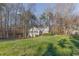 Home nestled on a large lot with lush green grass and mature trees at 150 Hartwood Dr, Woodstock, GA 30189