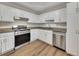 Well-lit kitchen with stainless steel appliances and granite countertops at 150 Hartwood Dr, Woodstock, GA 30189