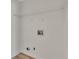 A bright, utility room featuring connections for laundry machines and an overhead wire rack shelf at 150 Hartwood Dr, Woodstock, GA 30189