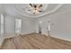 Spacious bedroom with tray ceilings, ceiling fan, and en suite access at 150 Hartwood Dr, Woodstock, GA 30189