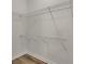 Walk-in closet features bright, open shelving and hardwood floors at 150 Hartwood Dr, Woodstock, GA 30189