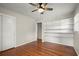 Bedroom with hardwood floors, shelving, neutral walls, a ceiling fan and closet at 2344 Sagamore Hills Dr, Decatur, GA 30033