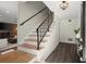 Inviting entryway featuring hardwood and carpet stairs with a black iron railing at 2344 Sagamore Hills Dr, Decatur, GA 30033