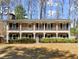 Two story brick home with a large front yard and large porch spanning the entire front of the home at 2344 Sagamore Hills Dr, Decatur, GA 30033