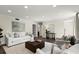 Bright living room featuring hardwood floors, white sofas, white chairs, and a brown leather ottoman at 2344 Sagamore Hills Dr, Decatur, GA 30033