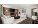 Living room features a brick fireplace and modern furniture on hardwood floors and a white rug at 2344 Sagamore Hills Dr, Decatur, GA 30033