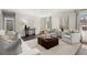 Sunlit living room with hardwood floors, modern furniture, and a large brick fireplace with a wall mounted TV at 2344 Sagamore Hills Dr, Decatur, GA 30033