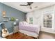 Cozy bedroom featuring hardwood floors, a white-framed bed, and natural light from the windows at 24 Rockland Pl, Decatur, GA 30030