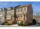 Charming brick townhome with manicured landscaping and inviting front entrance on a sunny day at 24 Rockland Pl, Decatur, GA 30030