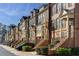Row of stately brick townhomes featuring covered entries, shutters, and manicured landscaping for curb appeal at 24 Rockland Pl, Decatur, GA 30030