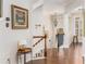 Bright hallway with hardwood floors, stairs, stylish lighting, and decorative artwork on the walls at 24 Rockland Pl, Decatur, GA 30030