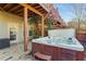 Outdoor hot tub featuring stone patio, a private wooden fence, and exterior door access for added convenience at 24 Rockland Pl, Decatur, GA 30030