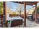Outdoor hot tub featuring wood trim, stone patio, and wooden fence with grill, great for relaxing and entertaining at 24 Rockland Pl, Decatur, GA 30030