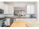 Modern kitchen with stainless steel appliances, light countertops, and a view of the living area at 24 Rockland Pl, Decatur, GA 30030