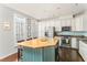 Bright, modern kitchen with a large island, white cabinets, stainless steel appliances, and hardwood floors at 24 Rockland Pl, Decatur, GA 30030