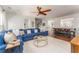 Bright living room features a blue sectional sofa, hardwood floors, and ceiling fan at 24 Rockland Pl, Decatur, GA 30030