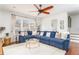 Open-concept living room with blue sectional sofa, hardwood floors, and bright windows at 24 Rockland Pl, Decatur, GA 30030