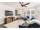 Inviting living room with blue sectional sofa, modern furniture, and a ceiling fan at 24 Rockland Pl, Decatur, GA 30030