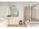 Main bathroom features a double vanity, standalone shower, and luxurious soaking tub at 24 Rockland Pl, Decatur, GA 30030
